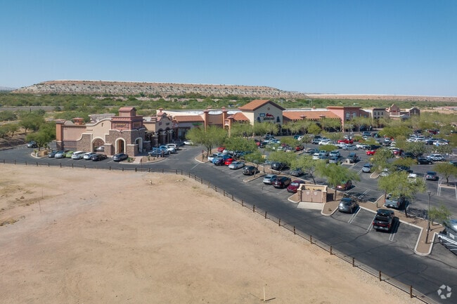 An elevated look at the flat mountains and the vast surroundings near Summit's retail stores.