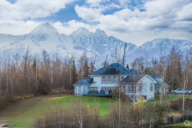 A large cottage in North Lakes with Pepper Peak behind it makes the Alaskan Dream.