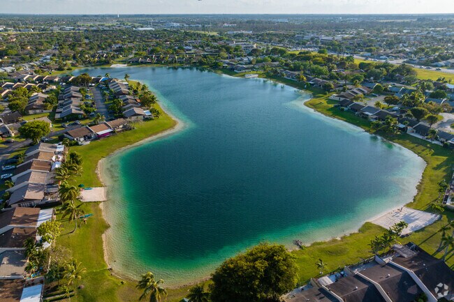 The lake in Devon-Aire is a tranquil oasis for fishing, kayaking, and paddle boarding.