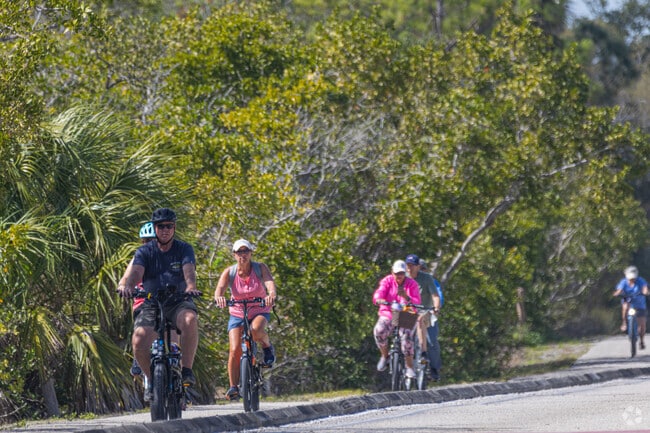 Cyclists ride along the paved pathways of Snead Isle.