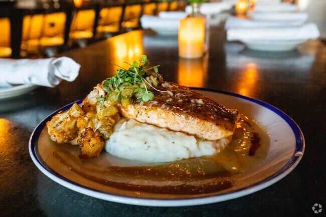 This salmon dish atop of a bed of mashed potatoes is only at the Noble Crust in Carrollwood, FL.