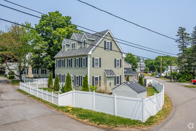 Colonial homes are often encircled by modern privacy fences in East Dedham.
