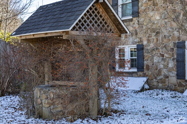 A unique well sits in front of an old house in Somerset Township.