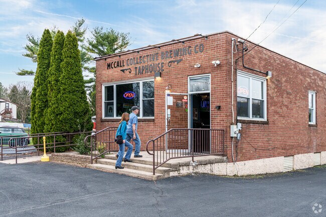 A couple heads through the unassuming brick facade of McCall's Taphouse for trivia night.