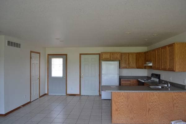 Kitchen with front half bath door, front door and garage door