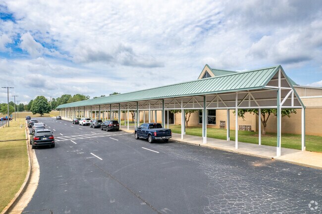 Luella Middle School has a covered car port for bus riders on rainy days.
