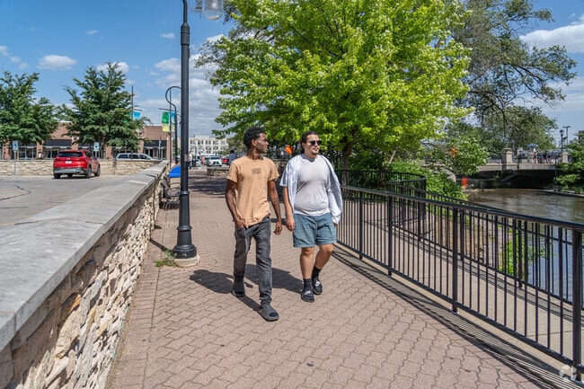 Two local men walk near the Naperville River Walk.