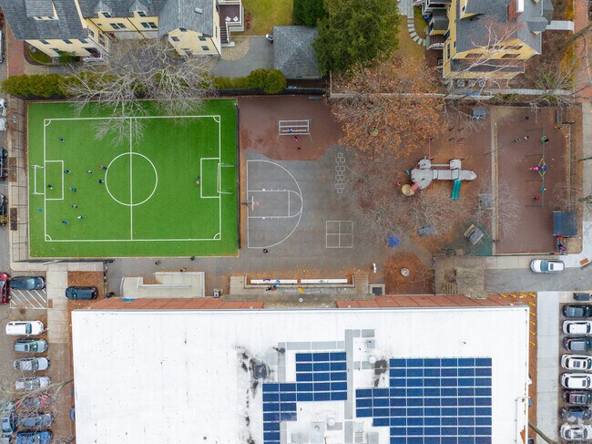 Kids enjoy a playground and turf at Graham & Parks School in Neighborhood Nine.