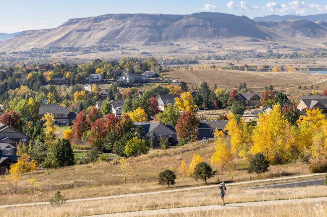 A resident stops to take in the views while jogging through the scenic paths of Spring Mesa.