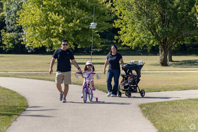 A family enjoys a walk and bike ride together at Baumann Park in Cherry Valley.