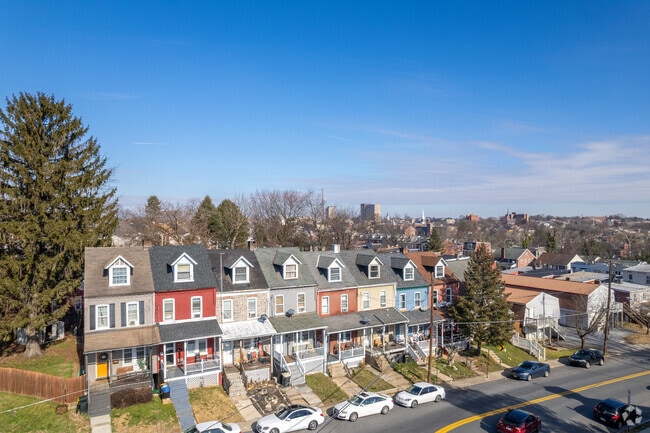 Colorful townhomes sit on top of a hill in Cabbage Hill.
