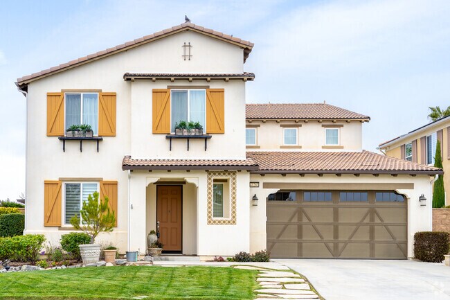 This Spanish Revival home in Serena Hills blends timeless charm with modern comforts, featuring stucco walls, red-tile roofs, and elegant arches.