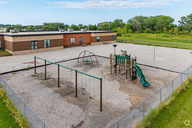 A playground with swings and slide is available to students at Evergreen Academy.