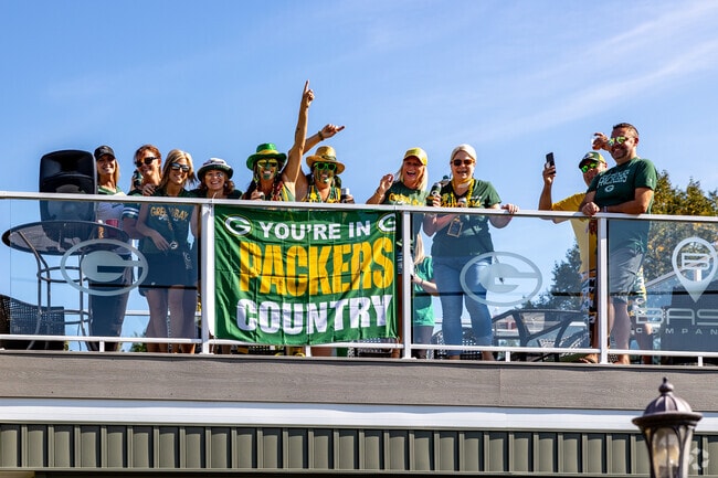 Residents from John Muir Park pass by pre-game festivities on their way to Lambeau Field.