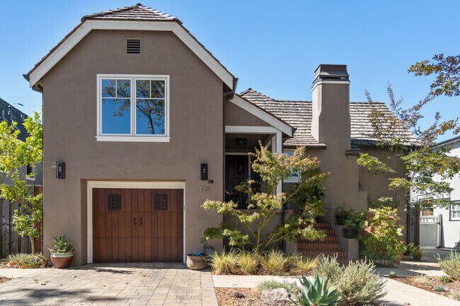 A modern Tudor-inspired residence in Oak Grove Manor offers clean lines and warm earth tones.