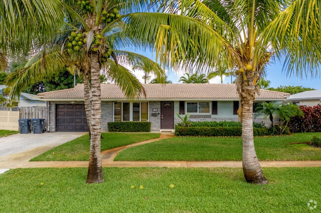 Single-family home with palm trees in Old Boynton.