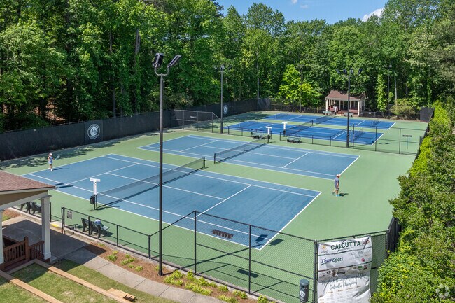 Medlock Bridge features well-maintained, lighted tennis courts ideal for recreational and competitive play in a scenic wooded setting.