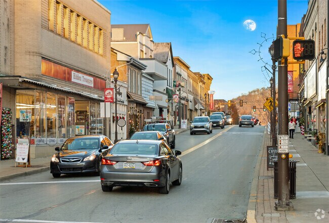 The moon can be seen over Pike St in Houston PA.