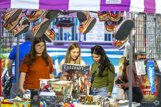 Shoppers browse unique local goods, embracing the festive energy of the Fair Harvest Fest.