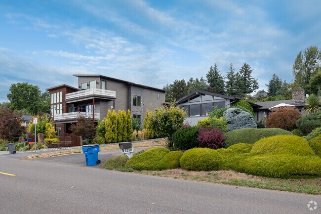 Contemporary homes sit next to mid-century homes along SE Riverside Dr in Riverview.