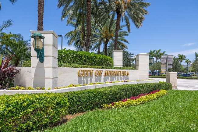 The city of Aventura signs welcomes you with flowers.