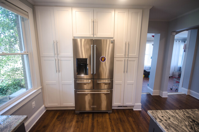 Large pantry with roll out shelves and appliance cabinet with hidden electrical sockets