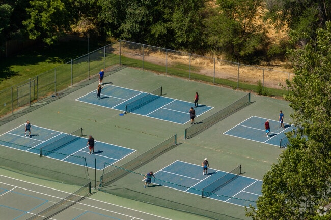 Residents of Vista can be seen playing a game of tennis at the park.