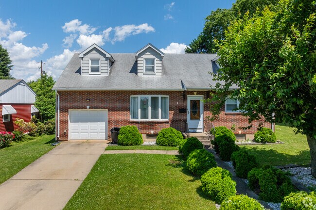 Cozy brick ranch and cape cod homes have driveways and garages in Highland Park.