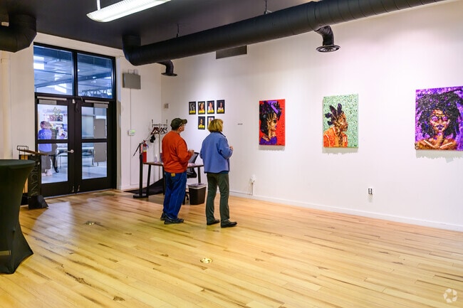 Visitors view the Keila Strong exhibition at the Black Arts & Culture during an ArtHop event.