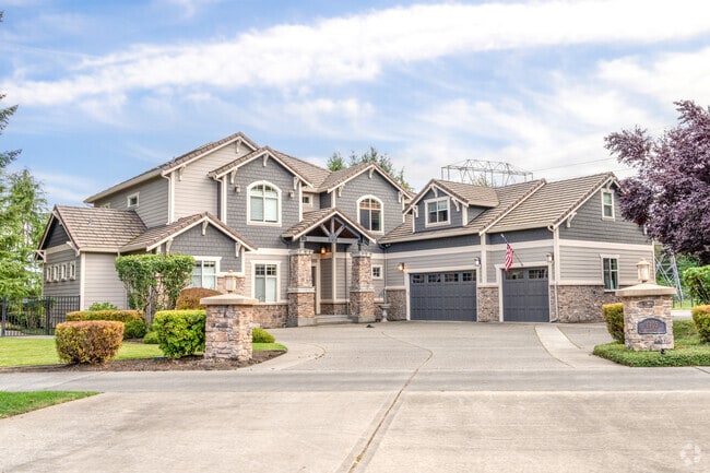 Spacious home with a grand façade, expansive yard, and elegant landscaping in Indian Summer.