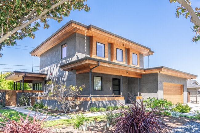 A modern home with flat roof and clean lines sits along a quiet street in Cuesta Park.