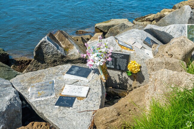 Memorials are stamped on the Jetty Rocks remembering South Beach loved ones.