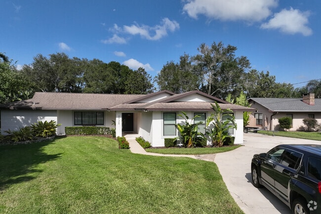 A white, stucco ranch style home in an established location of Lake Jasmine.