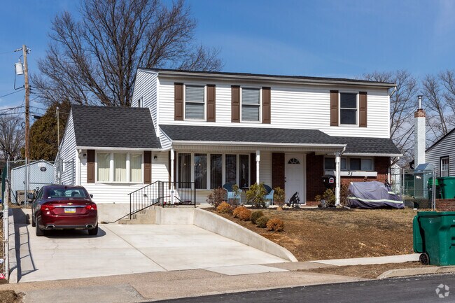 The owners of this colonial revival have increased their driveway for more parking.