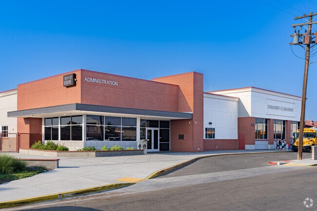 Students arrive by bus to Standard Elementary School in Bakersfield.