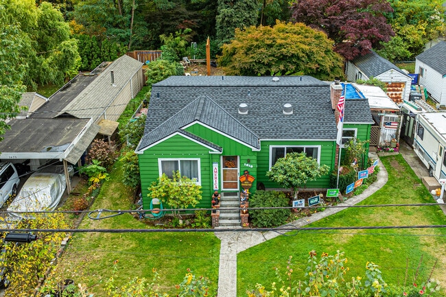 This stunning green cottage has an amazing paint job and yard in the Beverly Park neighborhood.