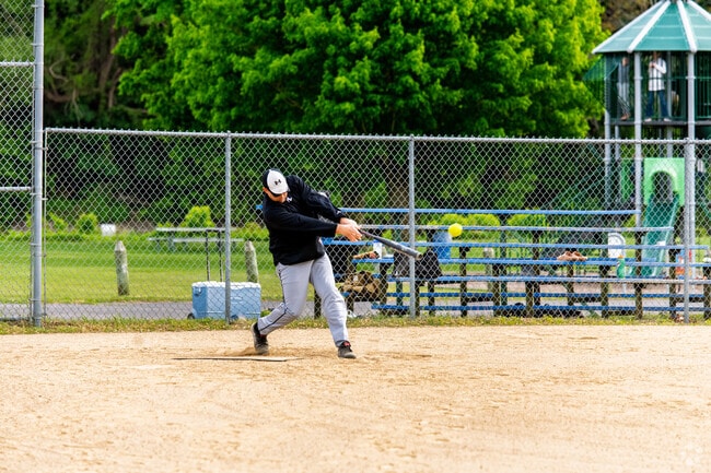 A softball player slams a hit at Carronde Park, located in Fair Plain.