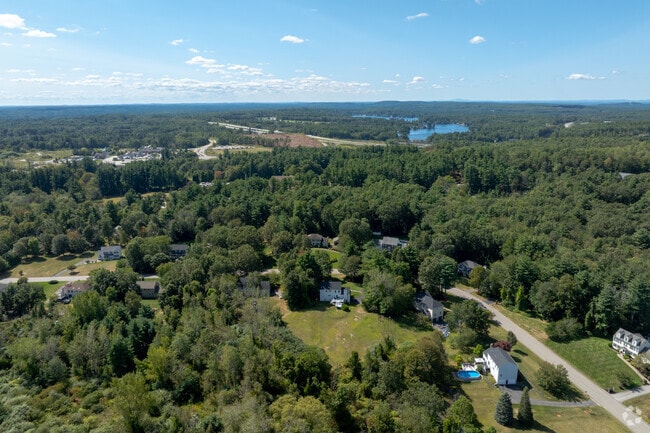 Homes in Windham often feature large lawns surrounded by verdant green trees.