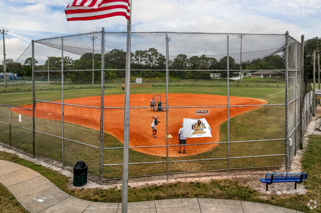 Port St. John locals take a practice swing on Fay Park baseball fields.