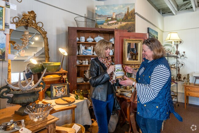 Two women admire a vase at Grove & Main Antiques near Greenfield.