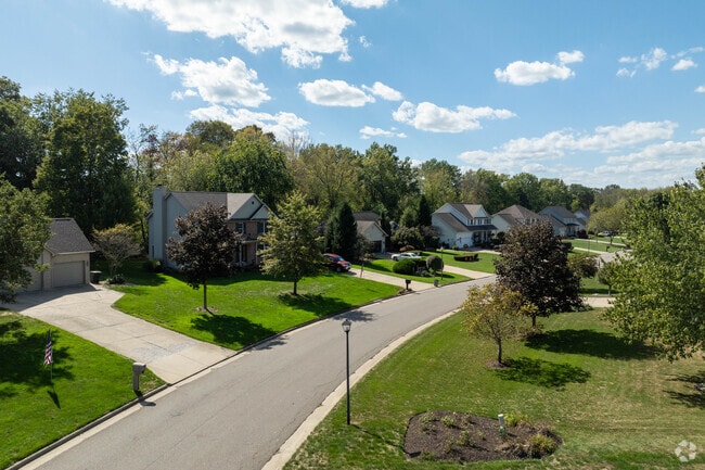 In Howland Center, several new traditional home designs are situated along a tree-lined street.
