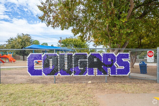 The vibrant sign showcasing the Cougars mascot at Eisenhower Elementary School in Norman.