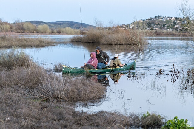 A family lands their canoe at the lake in Lake Elizabeth.