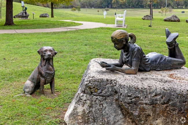 Lifelike statues can be seen throughout the Midway neighborhood displaying enjoyment.