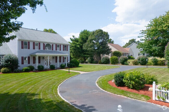 Custom homes with manicured lawns line Sagamore streets.