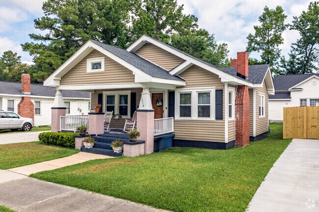 A Craftsman-style home in The Bottom features a well-manicured lawn.