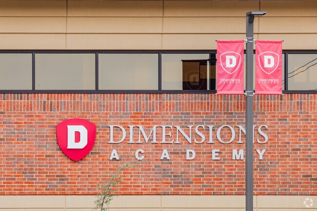 Close up shot of the signage of Dimensions Academy Elementary School.