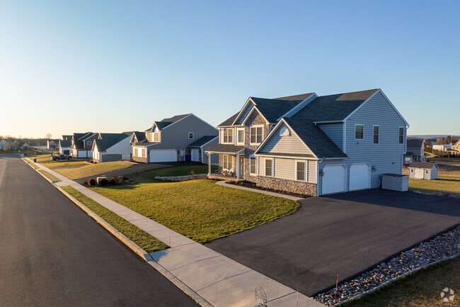A vivid sunset casts warm light on newly built homes in Rockland.