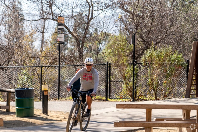 Cyclists ride around Almaden Lake Park for its trails and scenic lake views.