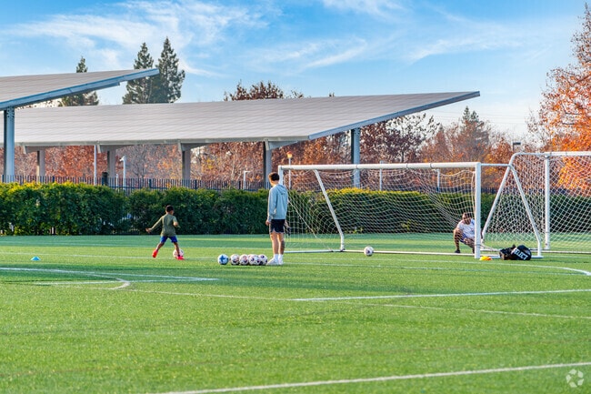 Young athletes train with their coaches at the Mather Sports Center .